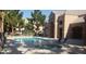 Community pool and spa with nearby seating and a clubhouse at 8101 W Flamingo Rd # 1073, Las Vegas, NV 89147