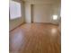 Bright living area featuring wood floors, natural light from the window, and an open floor plan at 8149 Palace Monaco Ave, Las Vegas, NV 89117