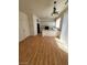 Hardwood floors connect the living area with a kitchen featuring white cabinets and an island at 8149 Palace Monaco Ave, Las Vegas, NV 89117