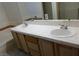 Bathroom vanity with double sinks, tiled countertop, and wooden cabinets at 8332 Shore Breeze Dr, Las Vegas, NV 89128