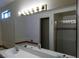 Bathroom featuring a large mirror, double sinks, and a shower with glass door at 8332 Shore Breeze Dr, Las Vegas, NV 89128