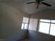 Well-lit bedroom with three windows, ceiling fan, and carpeted floors at 8332 Shore Breeze Dr, Las Vegas, NV 89128