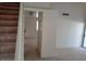 Hallway view featuring carpet, stairs to the left, and access to a living area at 8332 Shore Breeze Dr, Las Vegas, NV 89128