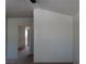 View of a room with an open doorway, light-colored walls, and neutral carpet at 8332 Shore Breeze Dr, Las Vegas, NV 89128