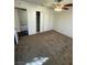 A bedroom with tan carpet, closet, and overhead lighting fixture at 834 Benita Pl, Boulder City, NV 89005