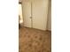 A bedroom with tan carpet, closet, and white door at 834 Benita Pl, Boulder City, NV 89005