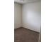 A view of an empty bedroom with brown carpet and white walls at 834 Benita Pl, Boulder City, NV 89005