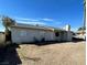 A house featuring a low-pitched roof, small windows, and stucco chimney at 834 Benita Pl, Boulder City, NV 89005