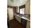 A modern kitchen with white cabinets, granite countertops, stainless steel appliances and new floors at 834 Benita Pl, Boulder City, NV 89005