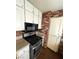 A modern kitchen with granite countertops, stainless steel appliances, and brick accents at 834 Benita Pl, Boulder City, NV 89005