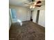 Bedroom with neutral carpet, ceiling fan, and access to an ensuite bathroom at 834 Benita Pl, Boulder City, NV 89005