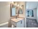Well-lit bathroom vanity with framed mirror, with a glimpse of the bedroom at 8425 Sewards Bluff Ave, Las Vegas, NV 89129