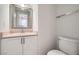 Cozy bathroom with a white vanity and framed mirror at 8425 Sewards Bluff Ave, Las Vegas, NV 89129