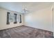 Spacious bedroom with neutral carpet, ceiling fan, and natural light from the window at 8425 Sewards Bluff Ave, Las Vegas, NV 89129