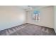 Empty bedroom with neutral carpet and a stained glass window at 8425 Sewards Bluff Ave, Las Vegas, NV 89129