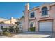 Two-story home featuring stucco siding, attached garage, and desert-style landscaping at 8425 Sewards Bluff Ave, Las Vegas, NV 89129