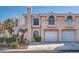 Two-story home with attached garage, stucco siding, arched windows and well-maintained landscaping at 8425 Sewards Bluff Ave, Las Vegas, NV 89129
