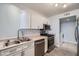 Galley kitchen featuring white cabinets and stainless steel appliances at 8425 Sewards Bluff Ave, Las Vegas, NV 89129