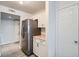 Kitchen area showcasing the stainless steel refrigerator and white cabinetry at 8425 Sewards Bluff Ave, Las Vegas, NV 89129