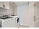 Functional laundry room with modern washer, dryer, and convenient storage cabinets at 8425 Sewards Bluff Ave, Las Vegas, NV 89129