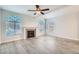 Bright living room featuring gray tile floors, a fireplace, and arched windows at 8425 Sewards Bluff Ave, Las Vegas, NV 89129