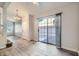 Open-concept living area with gray tile floors and a sliding glass door leading outdoors at 8425 Sewards Bluff Ave, Las Vegas, NV 89129