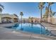 Community pool with lounge chairs and cabana, framed by palm trees and surrounding residences at 8425 Sewards Bluff Ave, Las Vegas, NV 89129