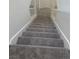 Carpeted stairway with white banisters leading to the upper level at 8425 Sewards Bluff Ave, Las Vegas, NV 89129