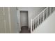 Clean entryway featuring gray floors, white walls, and white staircase to upper level at 8695 Canfield Canyon Ave, Las Vegas, NV 89178