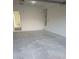 Spacious, empty garage with neutral walls and concrete flooring, ready for customization at 8695 Canfield Canyon Ave, Las Vegas, NV 89178