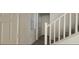 Bright hallway with a staircase and white doors, offering a clean and inviting transition between floors at 8695 Canfield Canyon Ave, Las Vegas, NV 89178