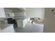 Bright kitchen boasts white cabinetry, modern appliances, and laminate flooring at 8695 Canfield Canyon Ave, Las Vegas, NV 89178