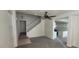 View of staircase, kitchen, and living room featuring modern light gray flooring at 8695 Canfield Canyon Ave, Las Vegas, NV 89178