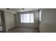 Spacious living room featuring gray flooring, neutral walls, and plenty of natural light at 8695 Canfield Canyon Ave, Las Vegas, NV 89178