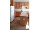 Kitchen featuring oak cabinets, a gas stove, a refrigerator, and an island at 8749 Brilliant Star Dr, Las Vegas, NV 89178
