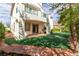 Backyard with covered patio and balcony overlooking synthetic lawn at 916 Granger Farm Way, Las Vegas, NV 89145