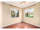 Bright bedroom with two large windows, ceiling fan, and neutral paint at 916 Granger Farm Way, Las Vegas, NV 89145