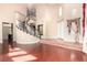 Grand foyer showcases a striking spiral staircase, high ceilings and wood floors at 916 Granger Farm Way, Las Vegas, NV 89145