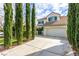 Attractive home boasts a two-car garage, lush landscaping, and a second story balcony at 916 Granger Farm Way, Las Vegas, NV 89145