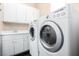 Bright laundry room with white cabinets, countertop and appliances at 916 Granger Farm Way, Las Vegas, NV 89145