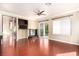 Spacious living room featuring modern hardwood flooring and a stylish ceiling fan at 916 Granger Farm Way, Las Vegas, NV 89145