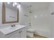 Clean bathroom with a single sink vanity and shower-tub combination at 924 Falconhead Ln # 102, Las Vegas, NV 89128