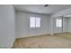 Spacious bedroom with a large window and mirrored closet doors at 924 Falconhead Ln # 102, Las Vegas, NV 89128