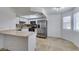 Modern kitchen with stainless steel appliances and a breakfast bar at 924 Falconhead Ln # 102, Las Vegas, NV 89128
