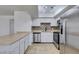 Well-equipped kitchen with stainless steel appliances and decorative tile backsplash at 924 Falconhead Ln # 102, Las Vegas, NV 89128
