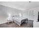 Bedroom with gray wood floors, a full sized bed, and white closet doors at 945 Vegas Valley Dr, Las Vegas, NV 89109
