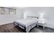 Bedroom with gray wood floors, a full sized bed, and a window with wooden blinds at 945 Vegas Valley Dr, Las Vegas, NV 89109