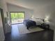 Bright bedroom features a sliding glass door to balcony and sleek dark hardwood floors at 945 Vegas Valley Dr, Las Vegas, NV 89109
