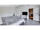 Spacious bedroom with wood floors, a TV on a console, a walk-in closet and access to a bathroom at 945 Vegas Valley Dr, Las Vegas, NV 89109