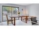 Bright dining room with a view of the pool through a large sliding glass door, wooden table and neutral decor at 945 Vegas Valley Dr, Las Vegas, NV 89109